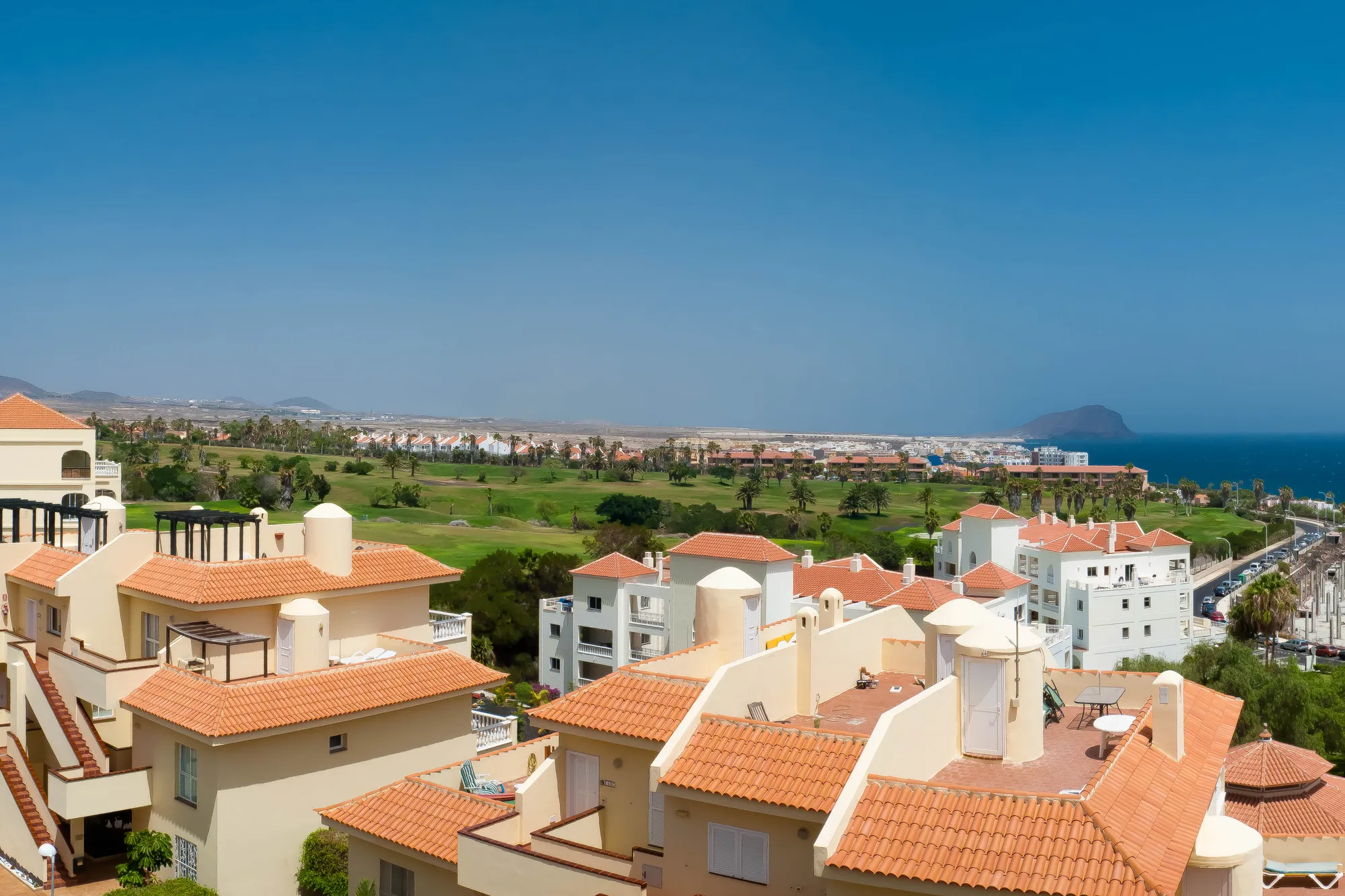 Golf del Sur from above, with the golf course and Montaña Roja beyond